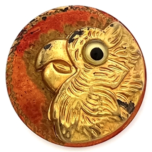 Parrot head button with glass eye.
