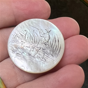 A 19th c. Pearl sporting button of a hunter with gun and dog. 