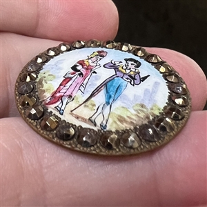A 19th c. Polychrome enamel button of a courting couple with cut steel border.