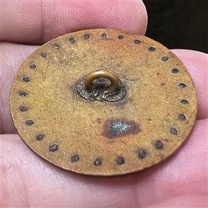 A 19th c. Polychrome enamel button of a courting couple with cut steel border.