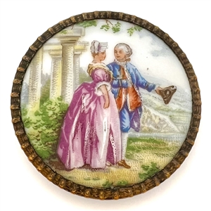 Transfer and painted porcelain button of a man and woman viewing land. 