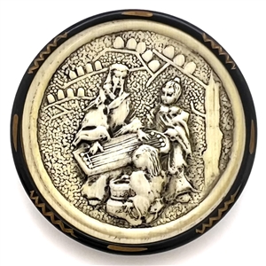 Ivoroid button of an Asian man playing a zither. 