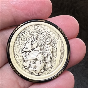 Ivoroid button of an Asian man playing a zither. 