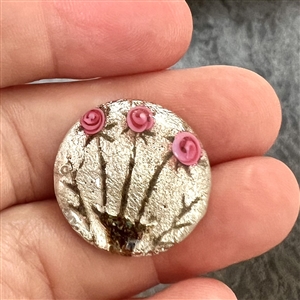 Div I glass with foil background button of roses. 