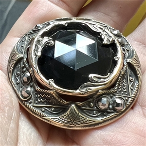 Gorgeous true Gay 90's button with faceted black glass center, cut-steels and inner border of flowers. 