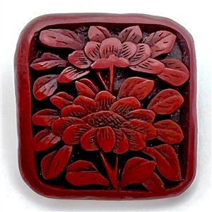 Older Chinese carved cinnabar button of peony flowers.