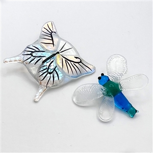 Two glass buttons of flying creatures.