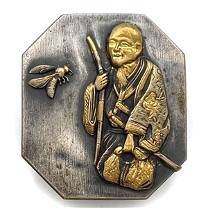 Octagon shaped button of a Japanese sage and insect.