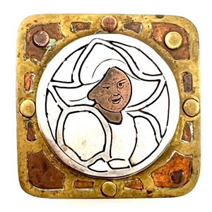 Modified square shape button of a Dutch girl in brass, copper and white metal.