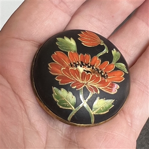 Painted and gold encrusted flowers on glass set in metal button.