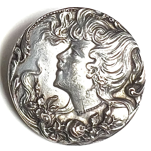 Silver plated brass button of an Art Nouveau woman.