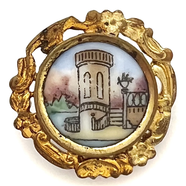 Transfer and painted porcelain button of a city scene set in gilded brass.