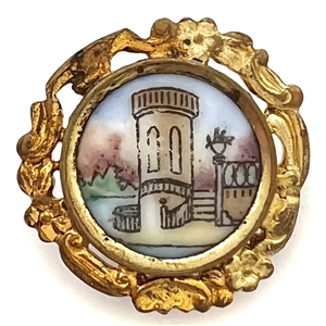 Transfer and painted porcelain button of a city scene set in gilded brass.