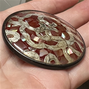 Extra large design under glass button of abalone chips and white metal.